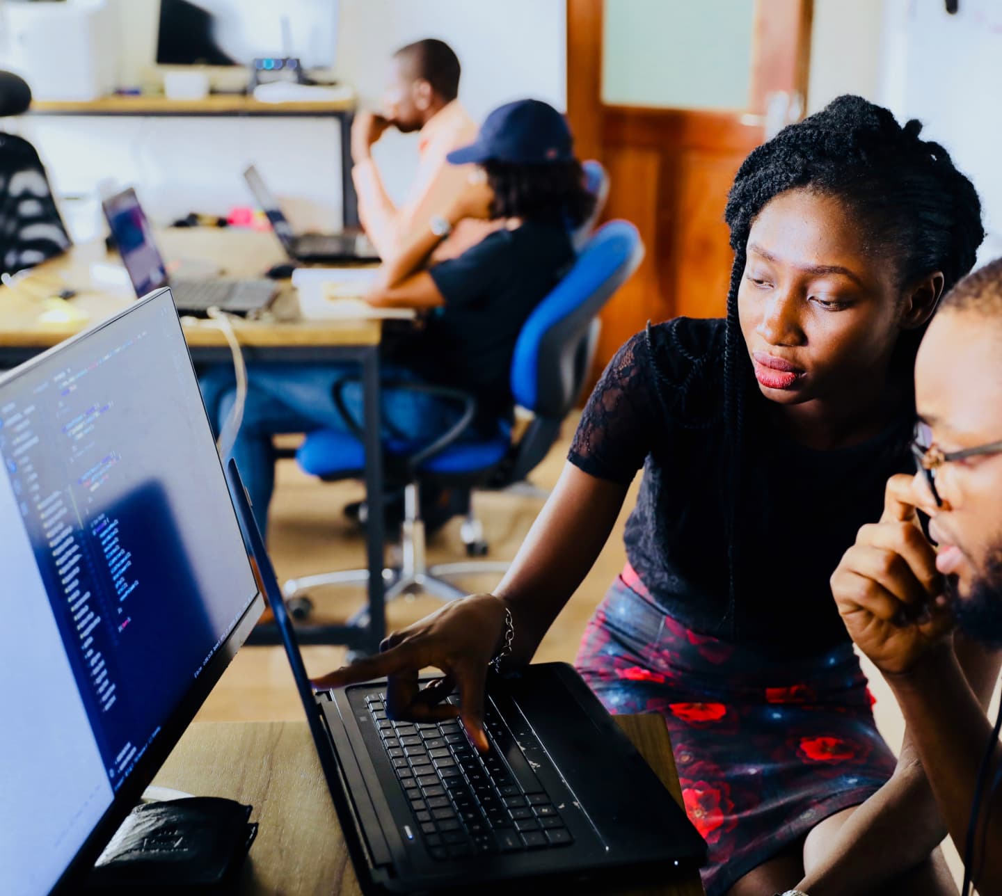 man and woman looking at laptop screen